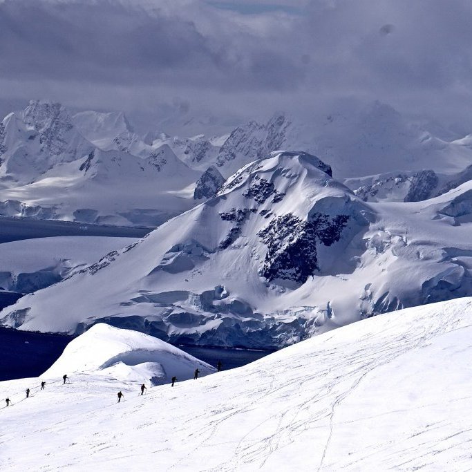 Groups of ski tourers ascending the slopes