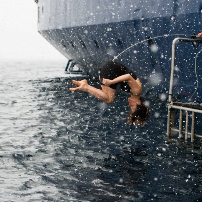 Guests take the cold water plunge while secured safely to the boat