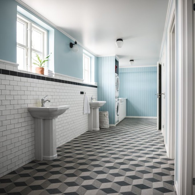 Lower level bathrooms and gear area at Karlsa Lodge, 2 toilets, 2 showers, washer and dryer