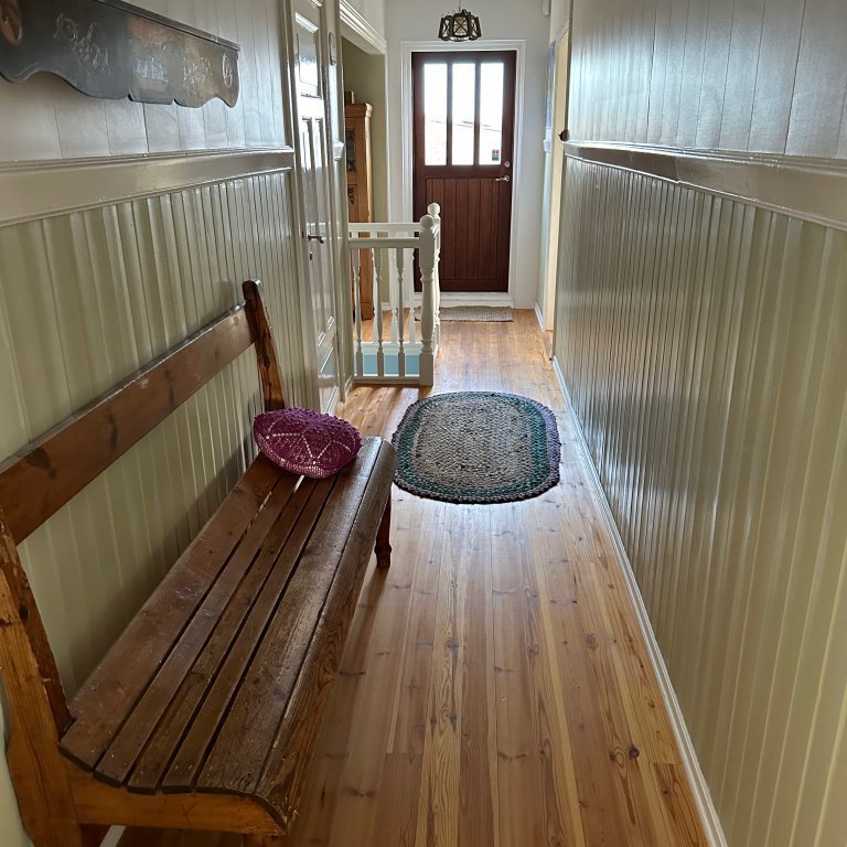 Hallway with small bathroom on the main floor.
