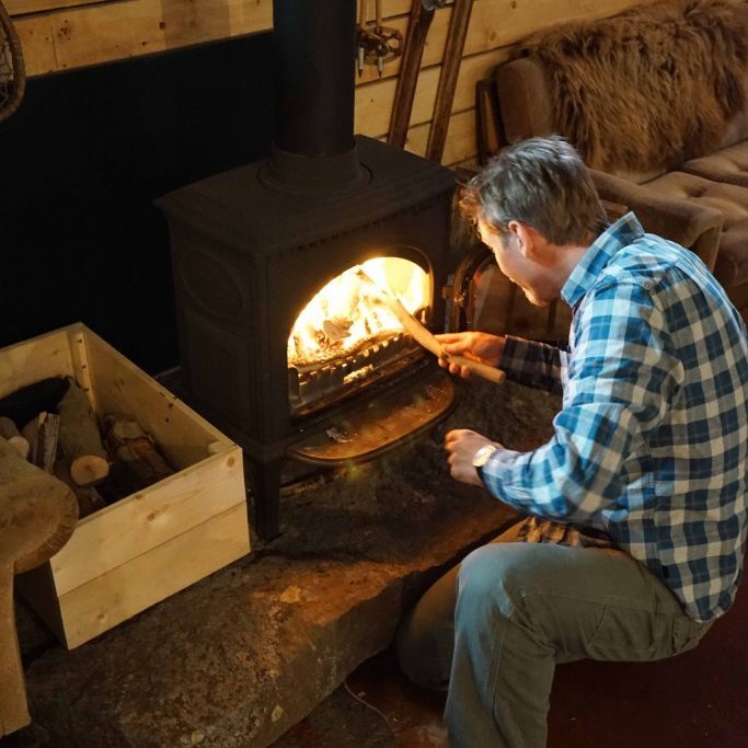 Róbert keeping the fire going in the Barn